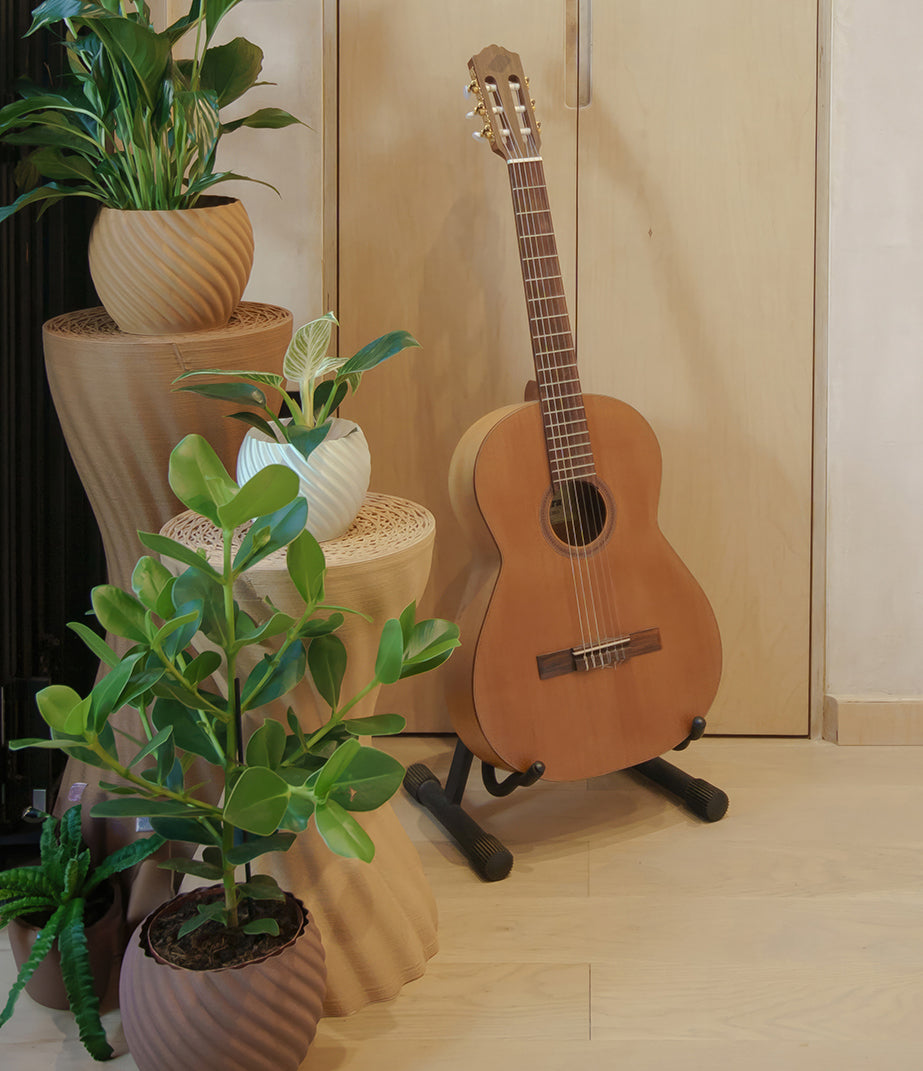 Mandala Planter Brown Brick by Fab.Pub with a plant in an interior setting
