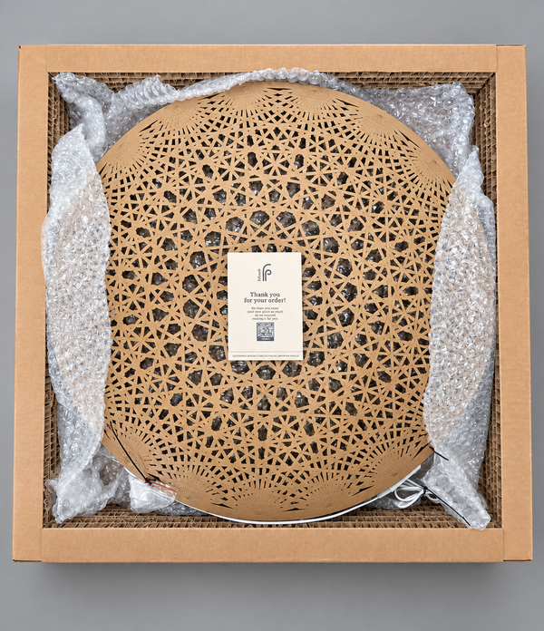 Mandala Wall Art unboxed, the wood-finish lattice disc resting in a kraft gift box with bubble wrap padding and a Fab.Pub thank you card