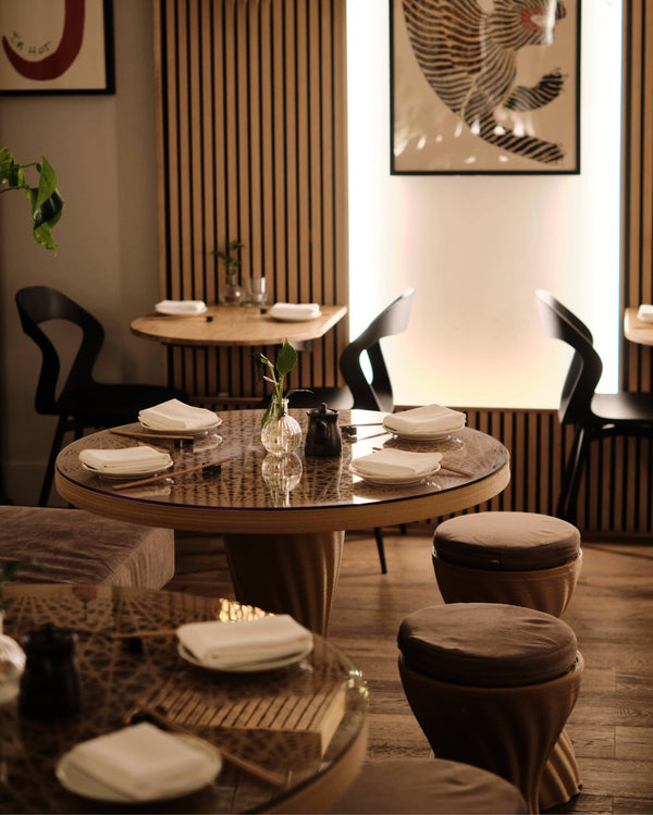 Mandala Bistro Table by Fab.Pub styled with chairs in a hospitality space