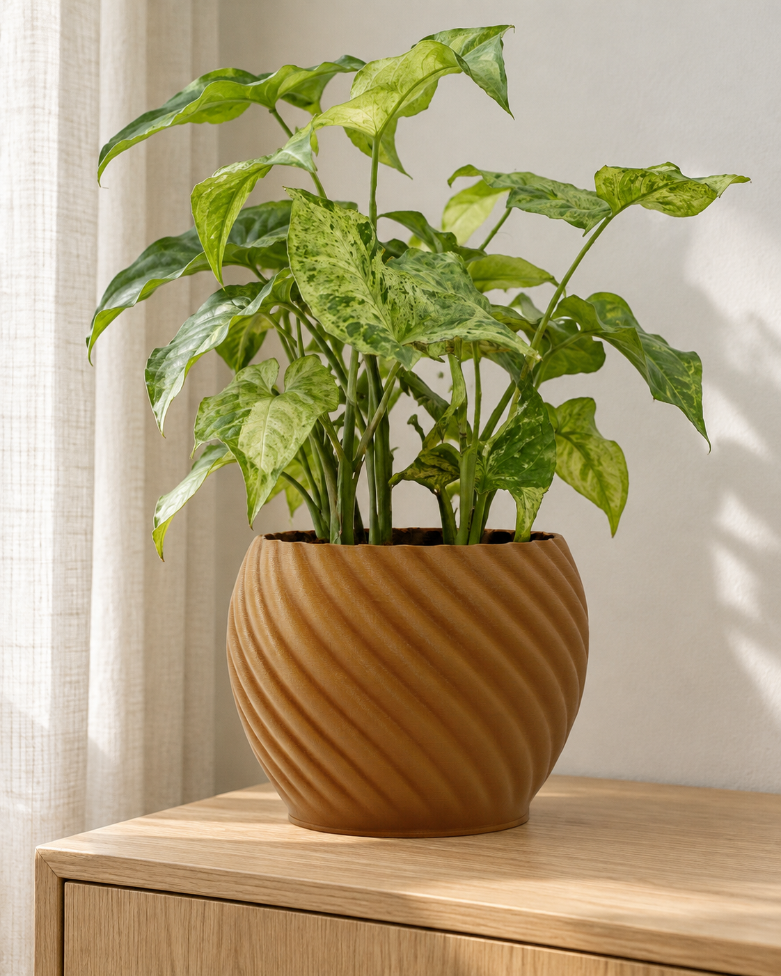 Styling visualisation based on the Mandala Brown Wood planter photograph, with fuller foliage on an oak sideboard. Plant and accessories not included.