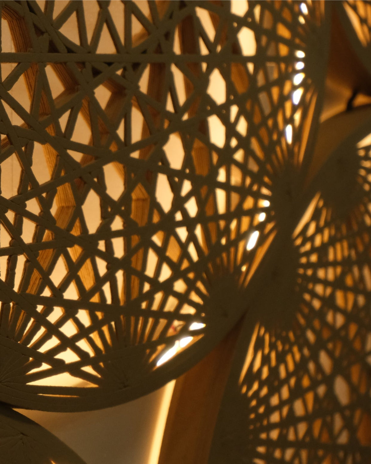 Detail view of a single wood tone mandala piece from the Aura Wall Art cluster